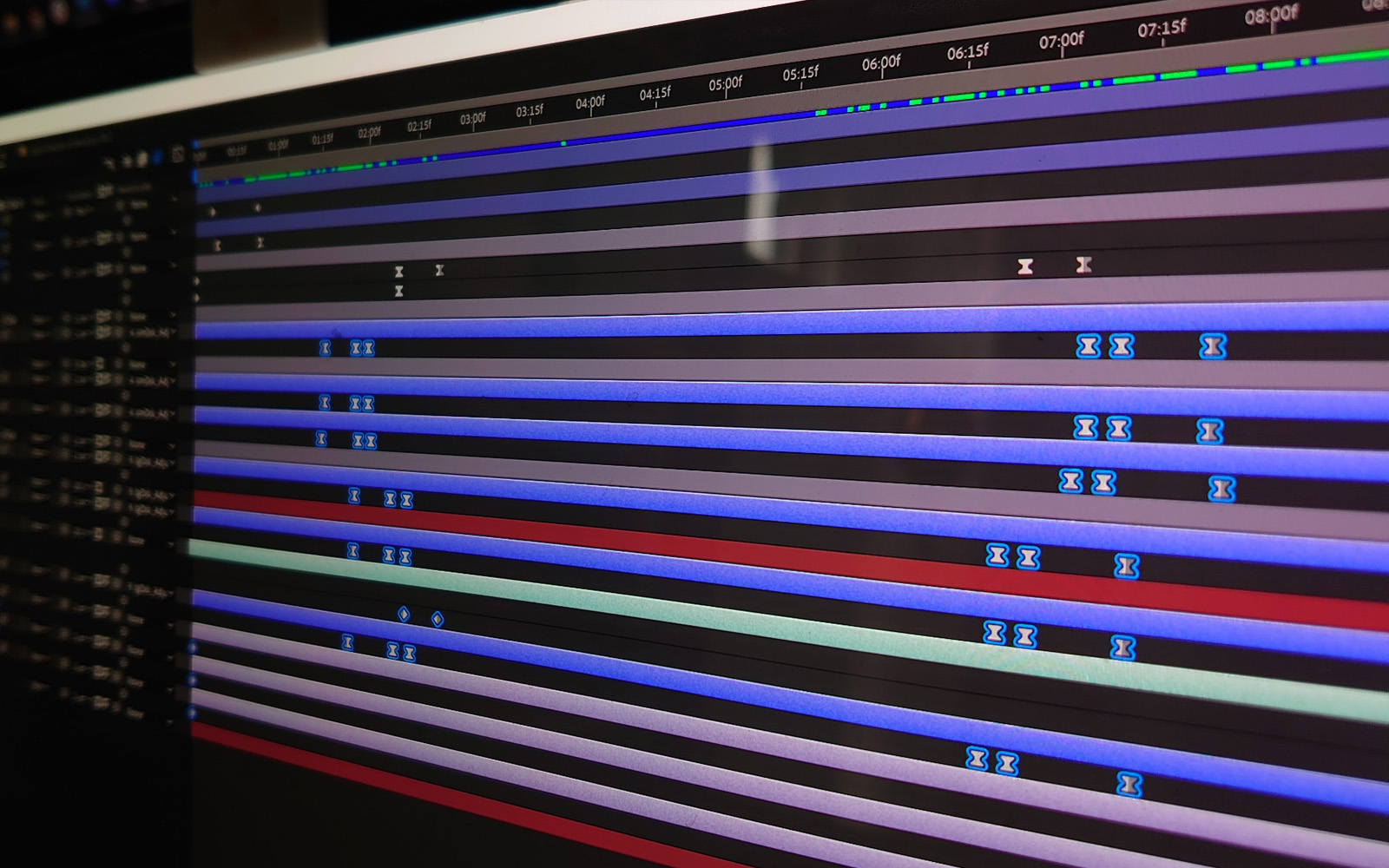 blurred out computer screen showing After Effects timeline