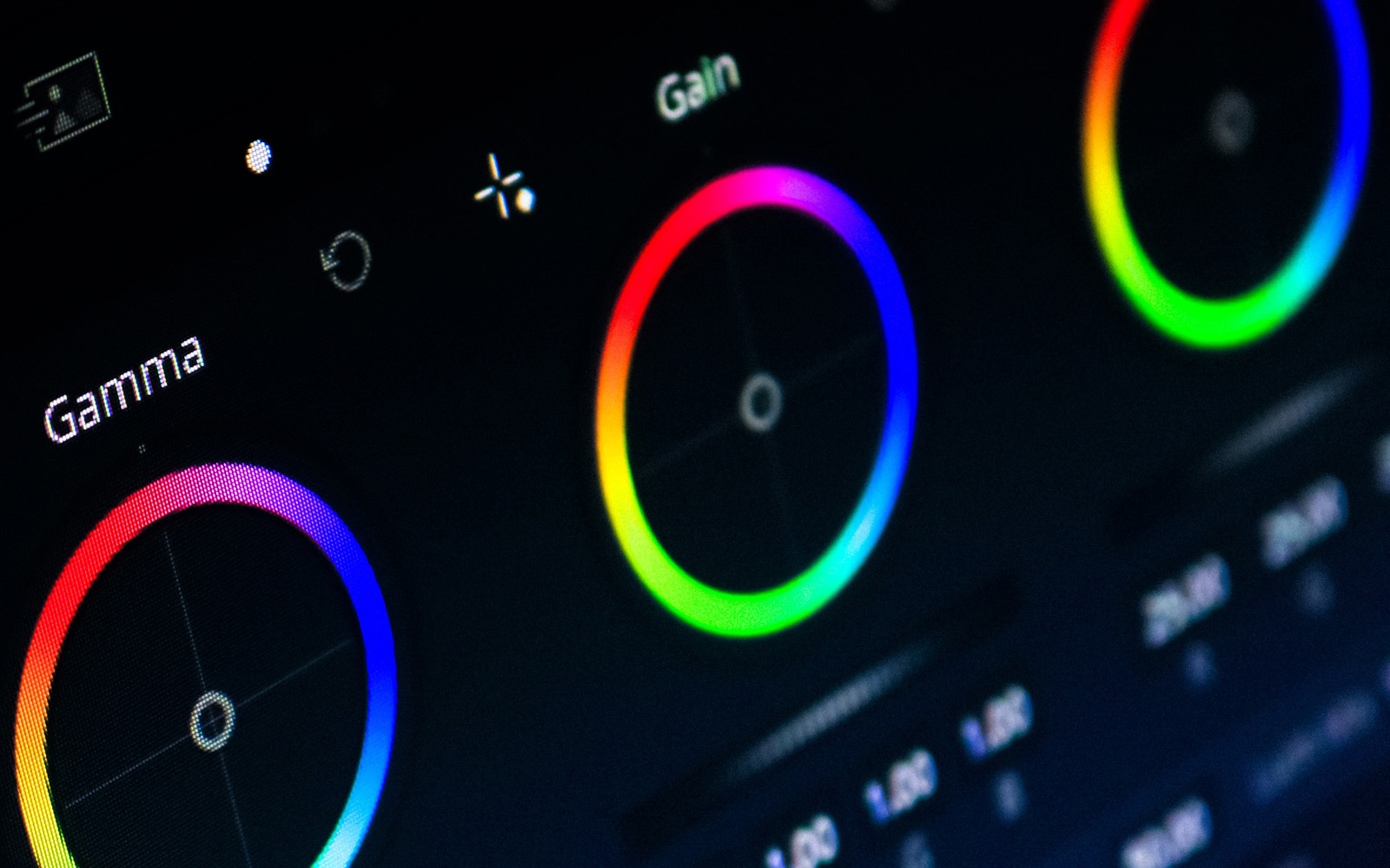 tight closeup of computer screen showing color wheels for footage grading